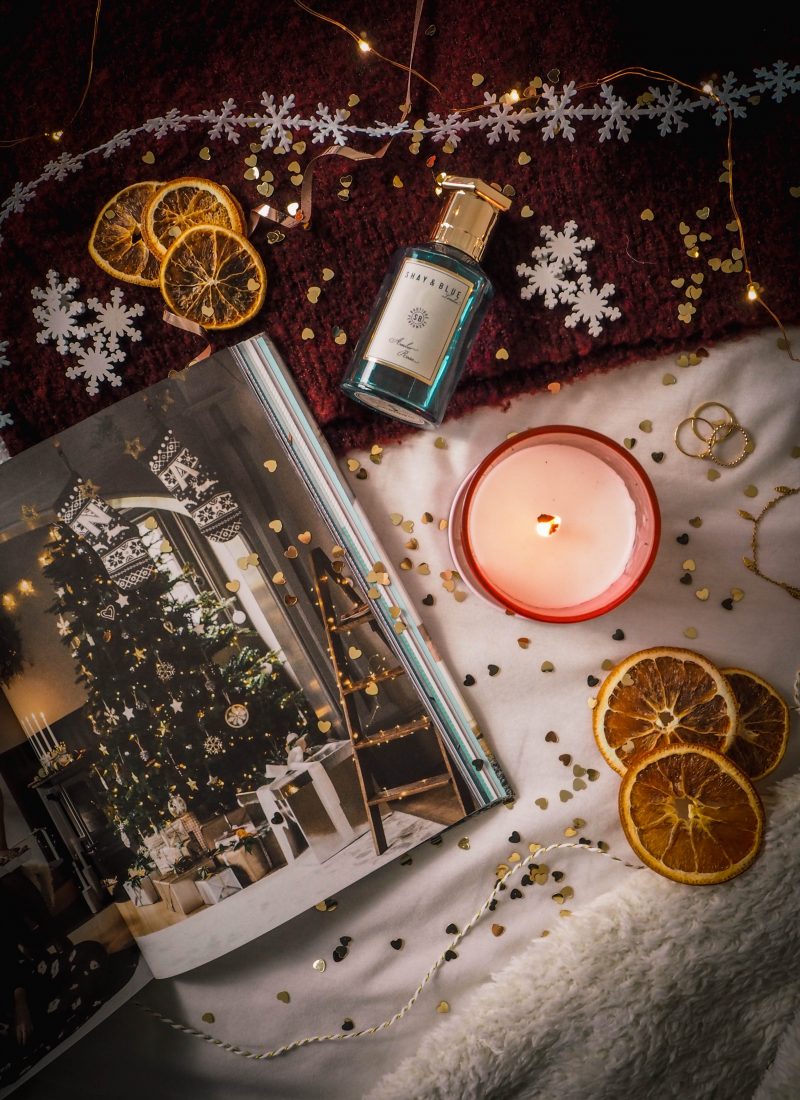 christmas book and candle flatlay